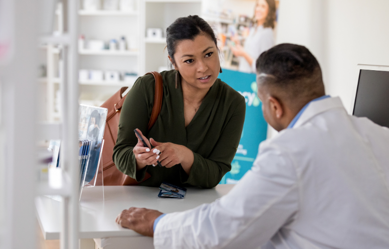 A lady talking to a pharmacist