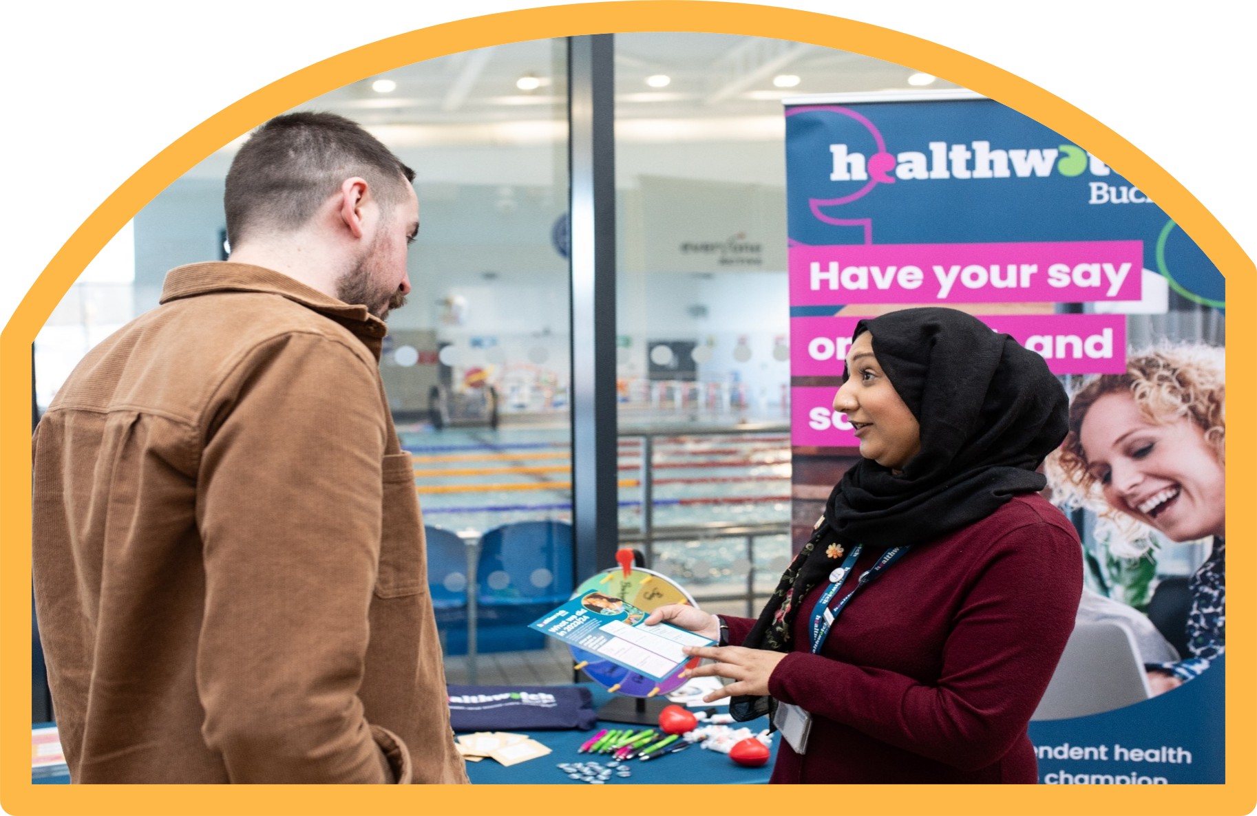 Image of a Healthwatch volunteer talking to a member of public about their expeirences