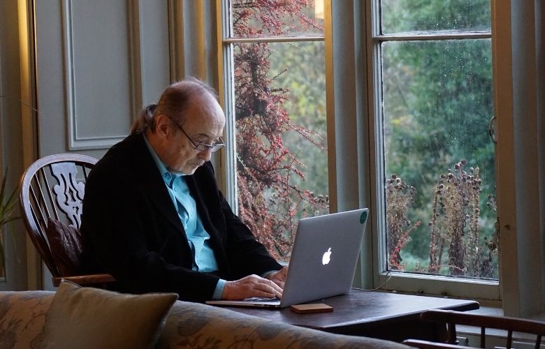 Picture of man using laptop in his home