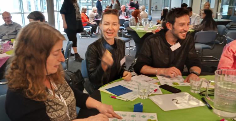 Table of two women and one man at annual meeting