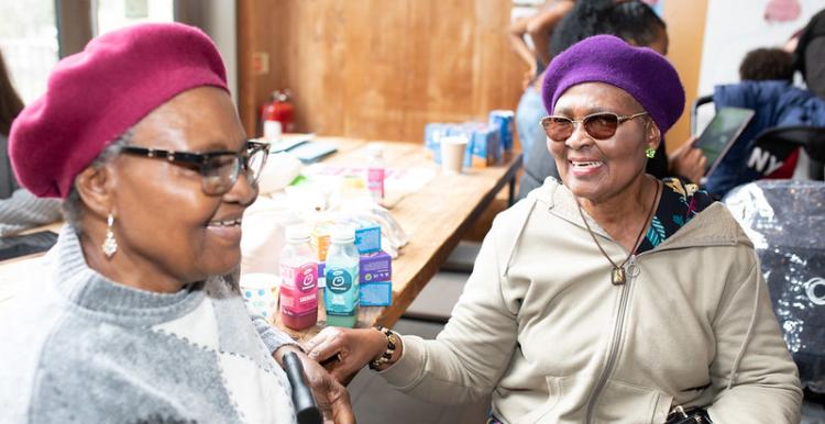 Two ladies talking to eachother at an event