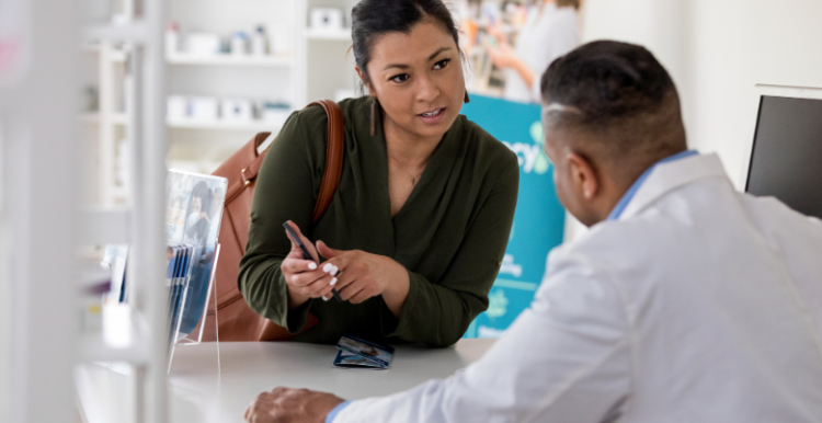 A lady talking to a pharmacist