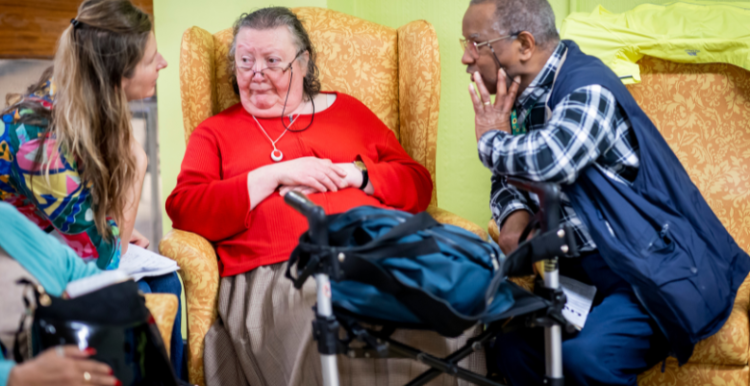 Three people sat talking together