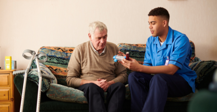 An elderly man receiving medication from a nurse