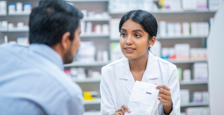 A person collecting their prescription from pharmacy