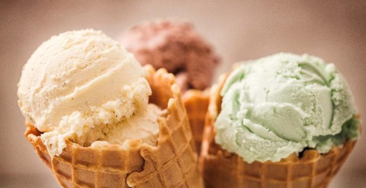 An image of three ice cream cones with ice cream in them 