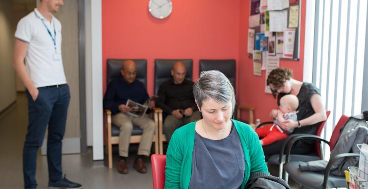 Woman reading a magzaine in a waiting room 