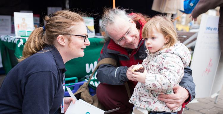 Healthwatch Volunteer talking to a little girl and her dad Healthwatch Volunteer talking to a little girl and her dad
