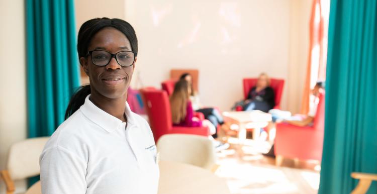 Black female care worker smiling at the camera