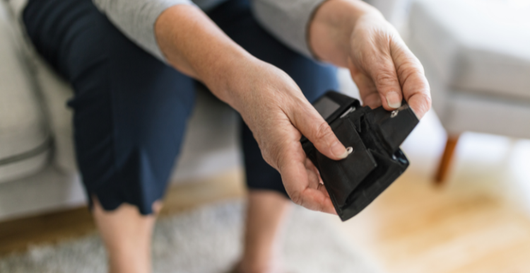 Image of a person's hands opening an empty purse