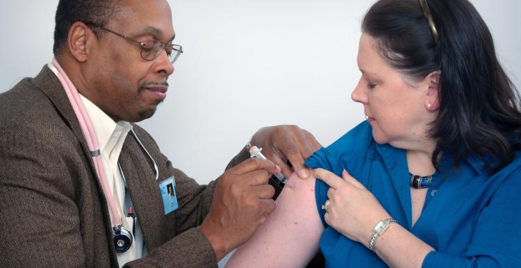 Doctor giving injection to a female patient Doctor giving injection to a female patient