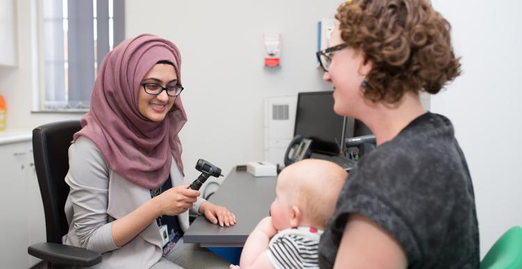 GP with a mother and baby patient 