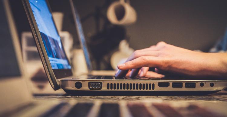 A person typing on a laptop