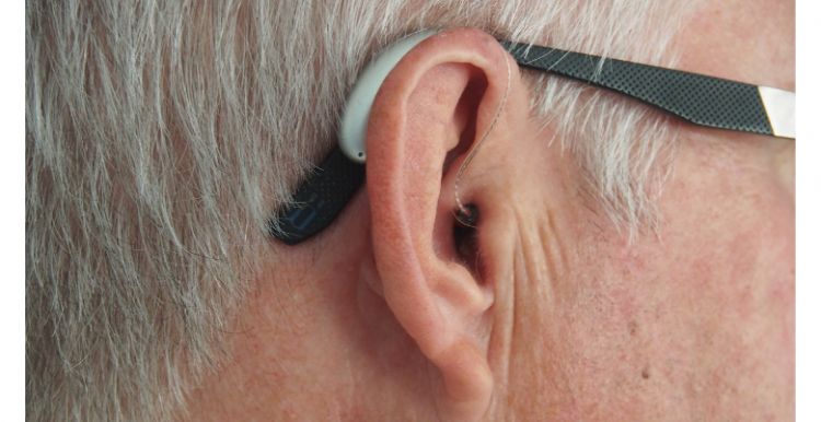 Side profile of a man wearing a hearing aid