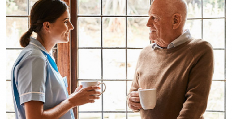 Man and carer drinking tea Man_and_carer_drinking_tea