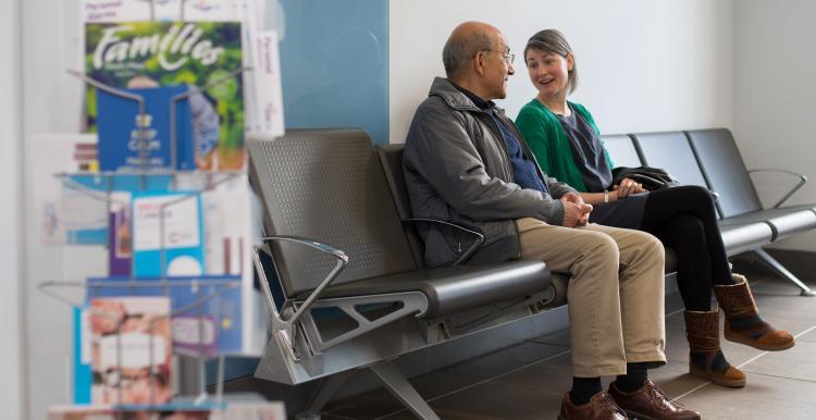 Two people talking in a waiting room Two people talking in a waiting room