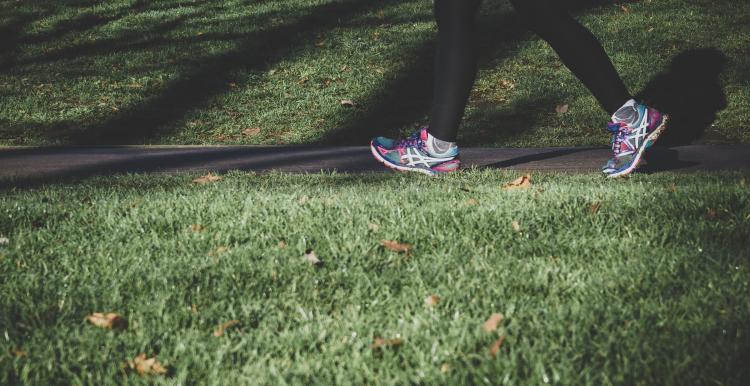 Person walking in trainers on path