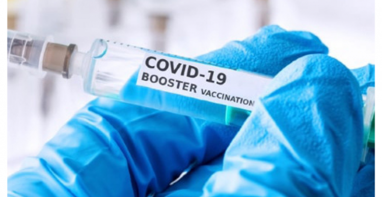 Booster vaccine Hands_holding_vial_labelled_booster_vaccine