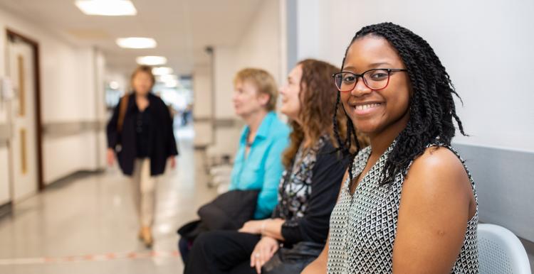 Woman smiling waiting in a hospital Woman smiling waiting in a hospital