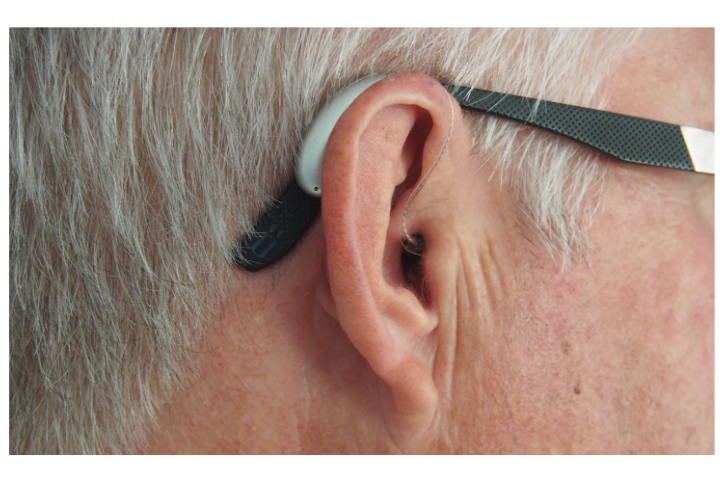 Side profile of a man wearing a hearing aid