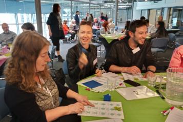 Table of two women and one man at annual meeting