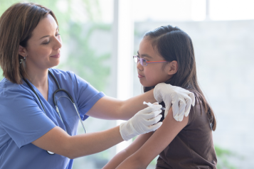 A young person getting a vaccination