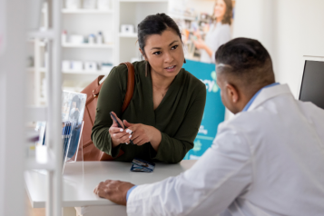 A lady talking to a pharmacist