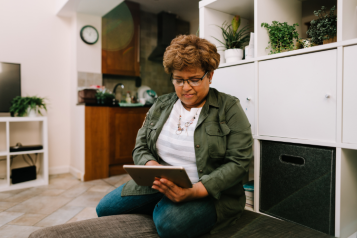 Lady using a tablet to book an appointment