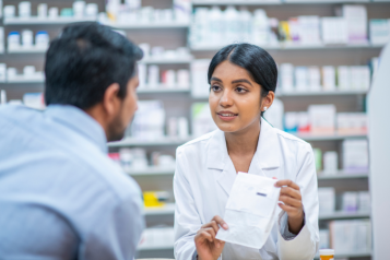 A person collecting their prescription from pharmacy