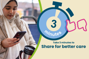 A young woman sits on a bus. She is wearing a headscarf. She is looking down at a mobile phone that she is holding in her hand.