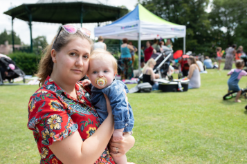 A lady holding her baby.