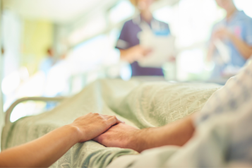 Holding hands with a family members at hospital visit