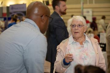 Lady asking questions to a man at an event