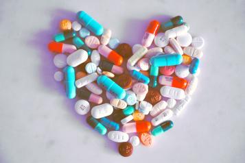 Prescription tablets laid out in the shape of a heart