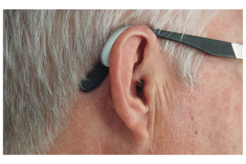 Side profile of a man wearing a hearing aid