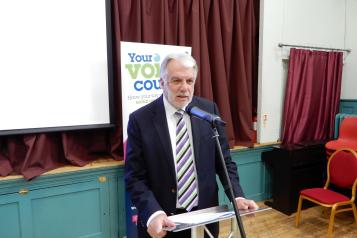 Chair of Healthwatch Coventry, Stuart Linnell, speaking at a meeting.