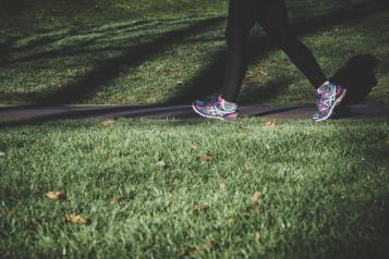 Person walking in trainers on path