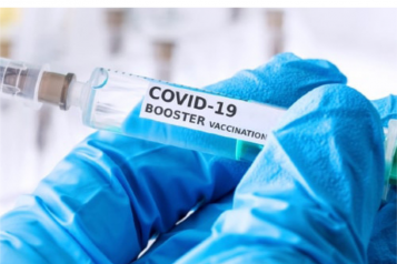 Hands_holding_vial_labelled_booster_vaccine