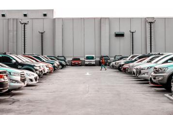 A lady walking through a car park