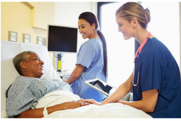 woman_in_bed_with_two_nurses_nearby