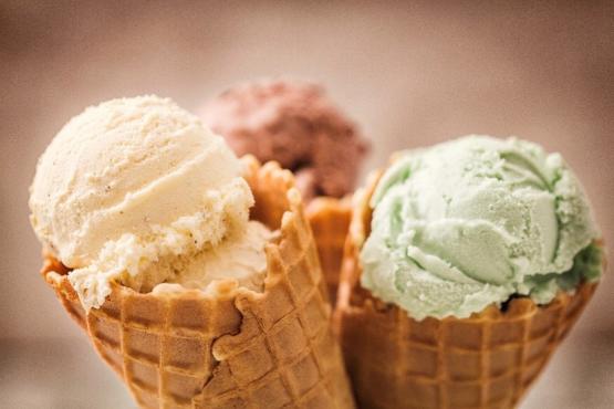 An image of three ice cream cones with ice cream in them 