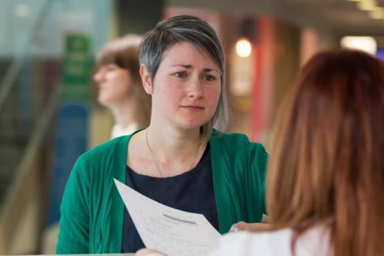 Woman at reception desk trying to complain