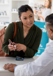 A lady talking to a pharmacist